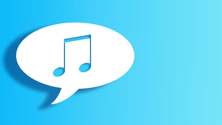 White Chat Bubble With Cut Out music note Shape Over Blue gradient Background with large copy space.