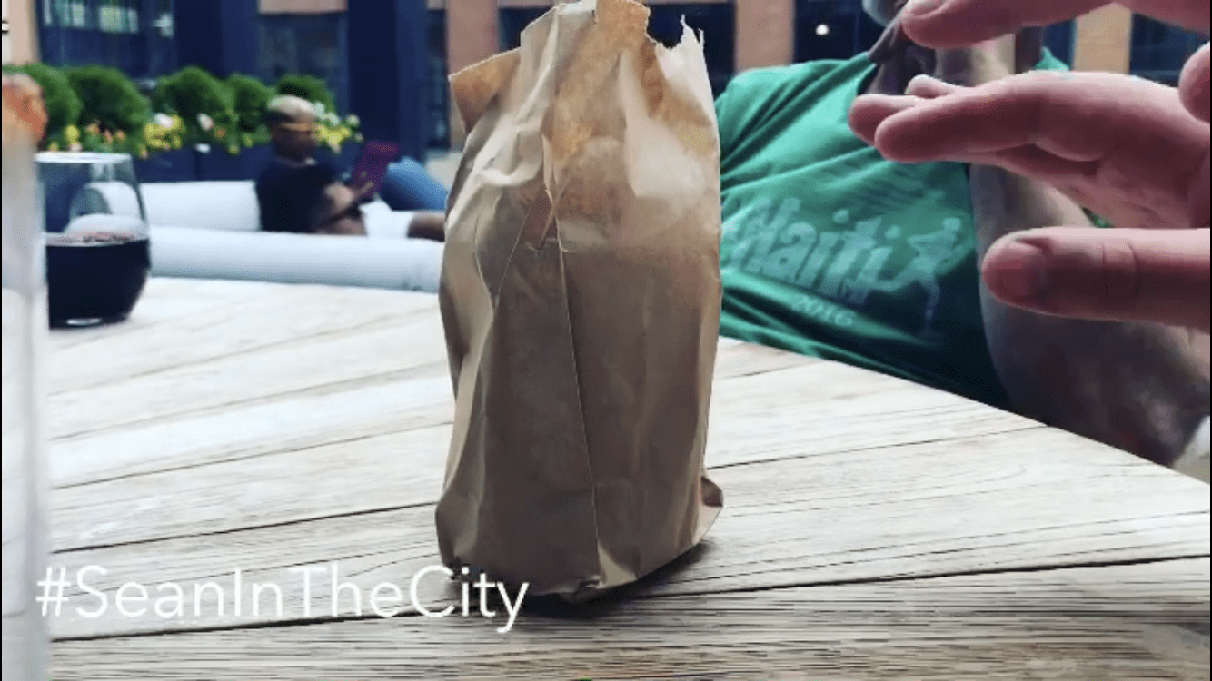 A can of beer in a brown paper bag