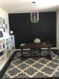 desk in front of wall painted black