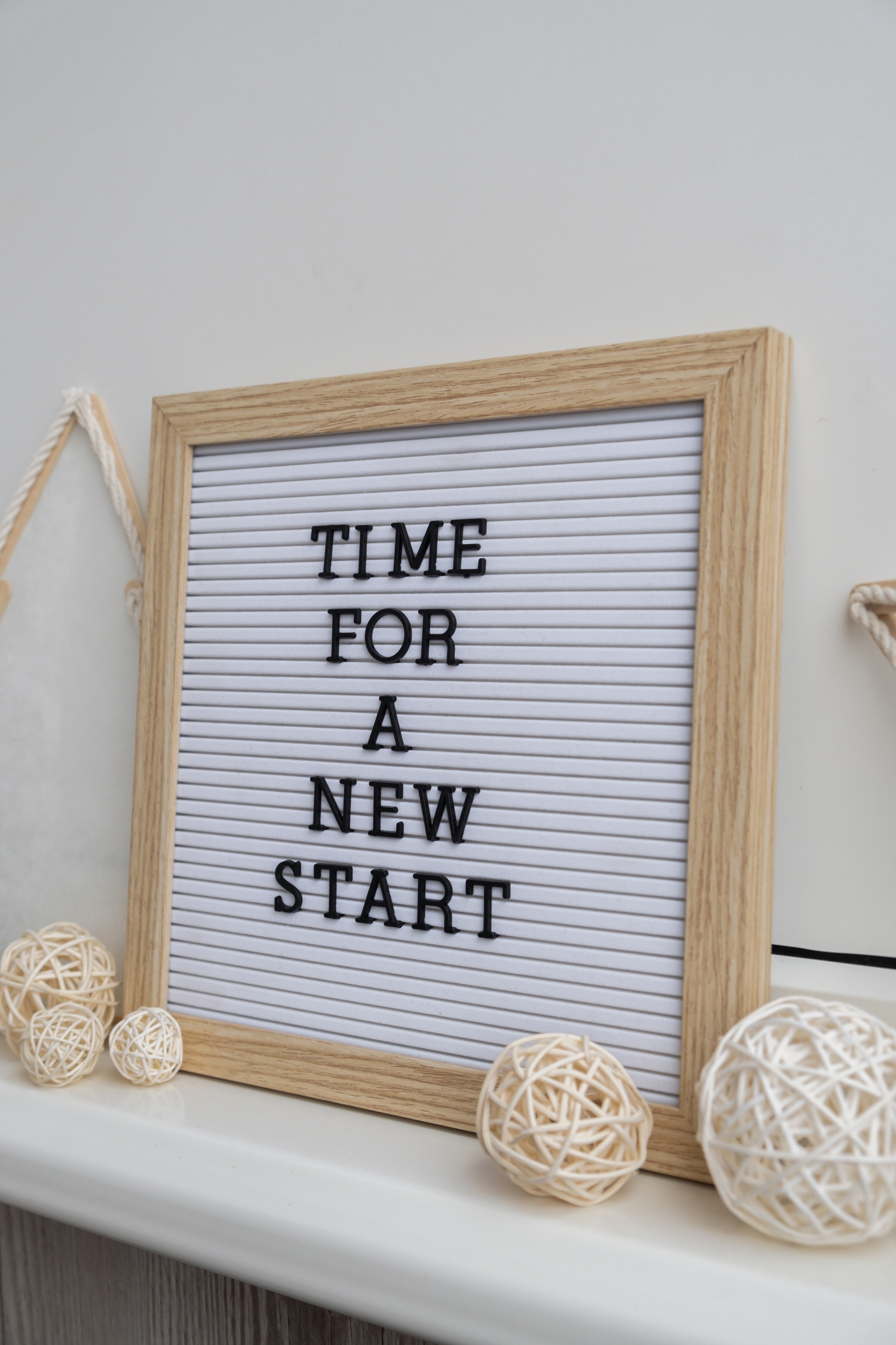 TIME FOR A NEW START text on black letter board with cozy minimalistic handmade Christmas decor. New year aims resolutions. Low key festive Planning and setting goals