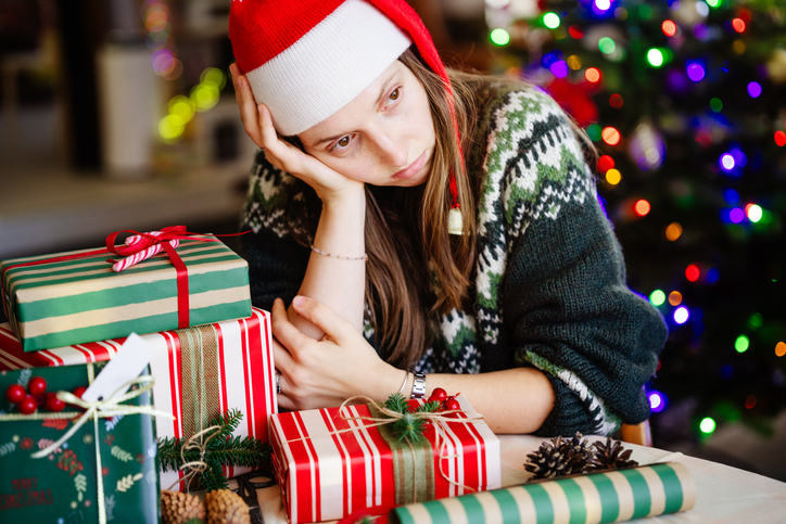 Sad young woman feeling lonely on Christmas holidays at home.
