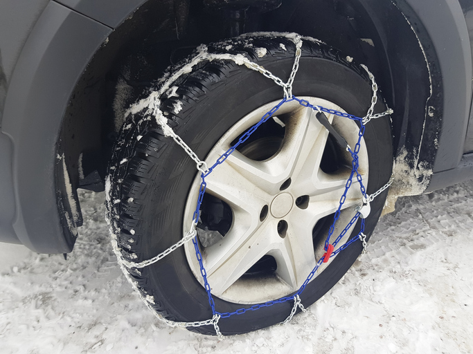 Close-Up Of Chains On Tire During Winter