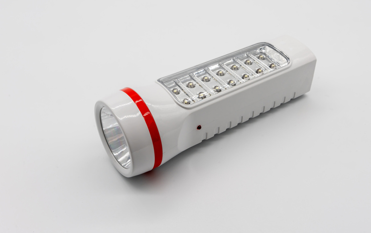 High Angle View Of Flashlight Against White Background