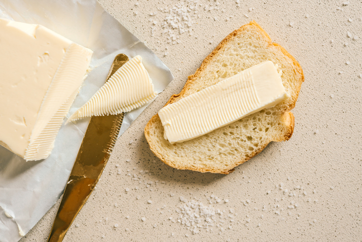 Slice of bread and butter. Closeup sourdough slice of homemade white loaf bread with butter.