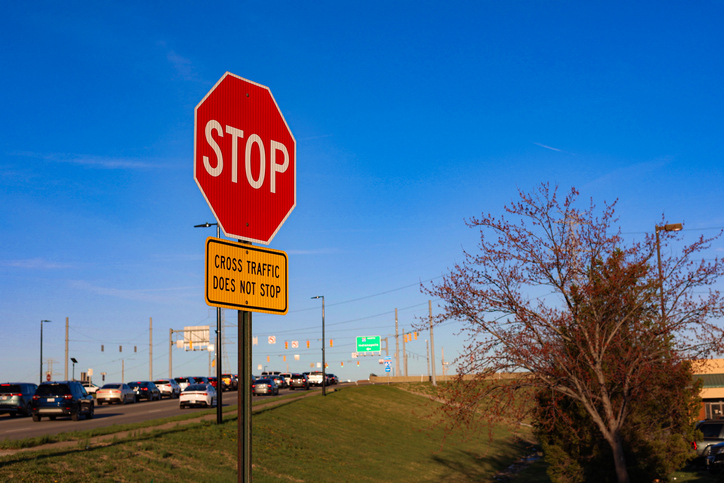 Stop sign with traffic and cars at rush hour