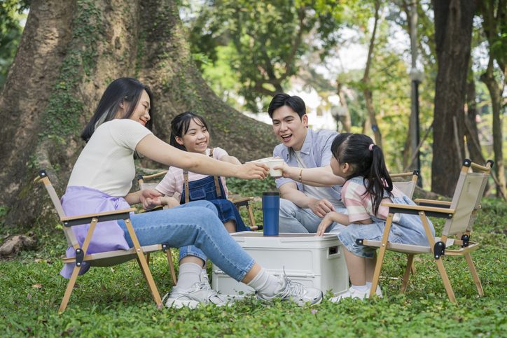 Happy Family Enjoying a Picnic in a Beautiful Park Setting