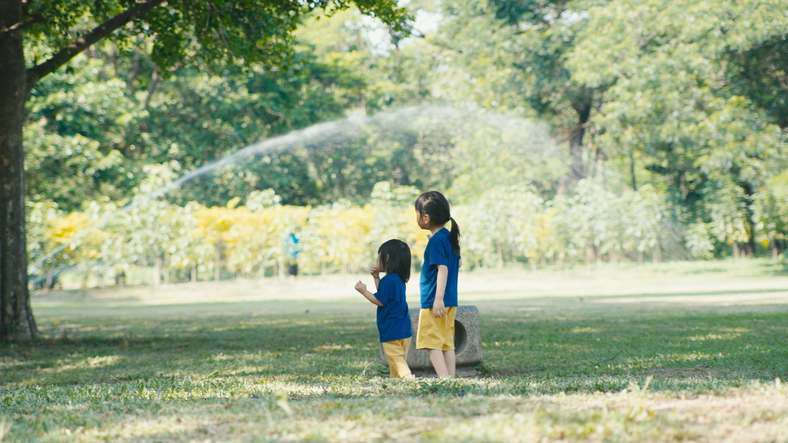 Little child and family resting in park