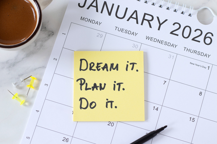 Dream, plan, do, inspirational handwritten quote on 2026 calendar with coffee cup